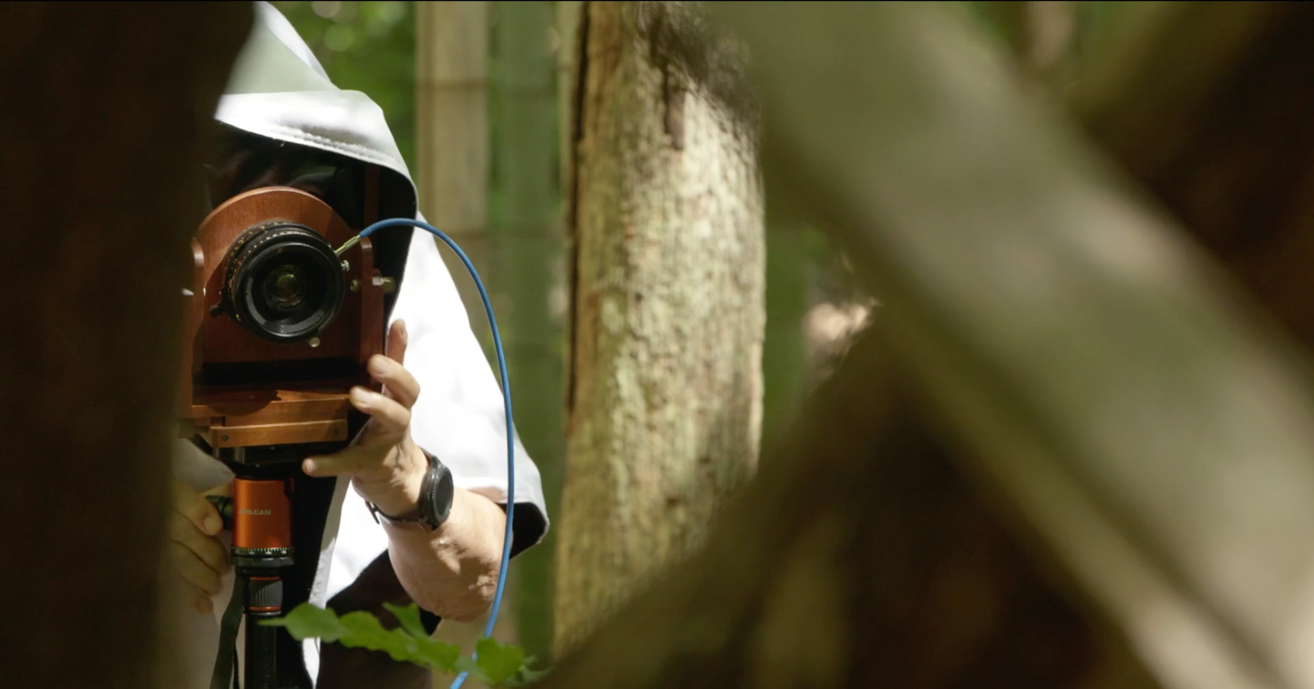Sam Wang with his camera in the forest